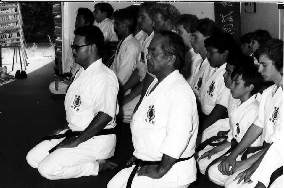 Masanobu Shinjo kneeling in seiza at the front of a line of students