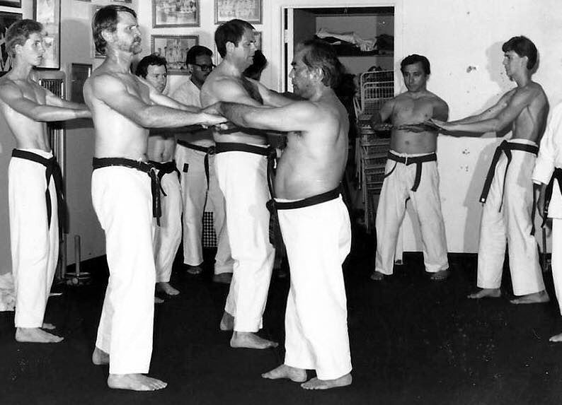 Masanobu Shinjo checking a student's Sanchin stance during testing