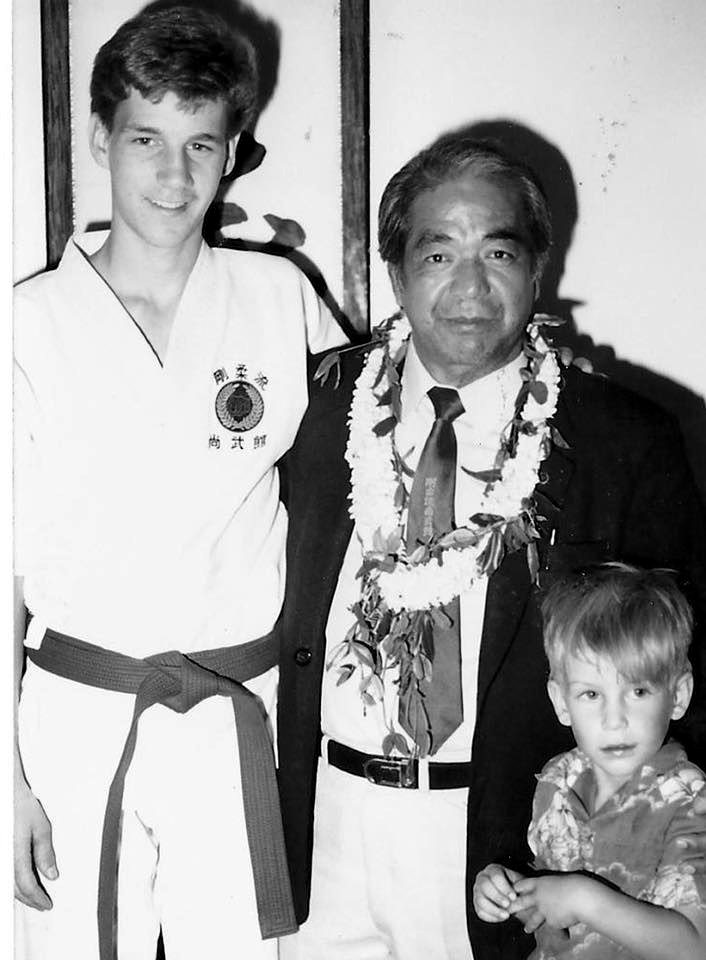Young Sensei Walker in a purple belt standing with Masanobu Shinjo
